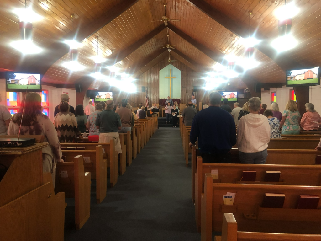 Congregation gathered inside a church sanctuary during a worship service.