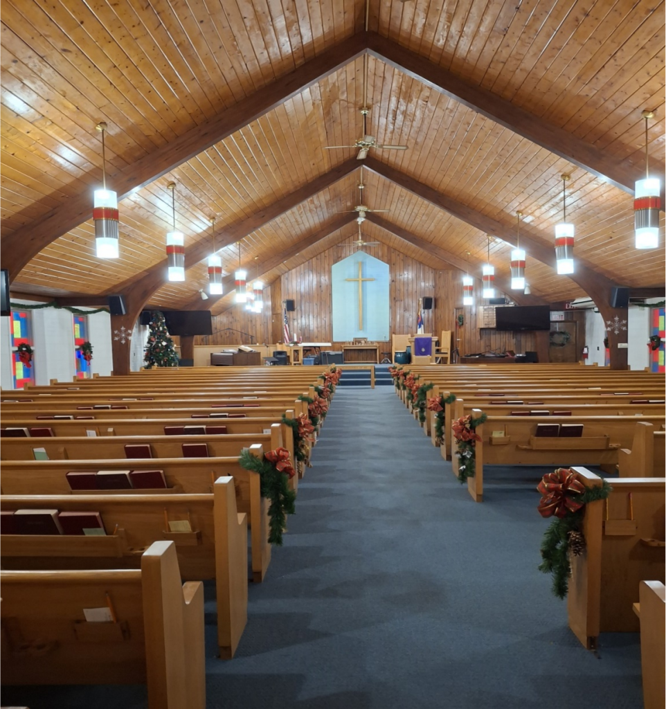 Interior of a church sanctuary decorated for a Christmas service.